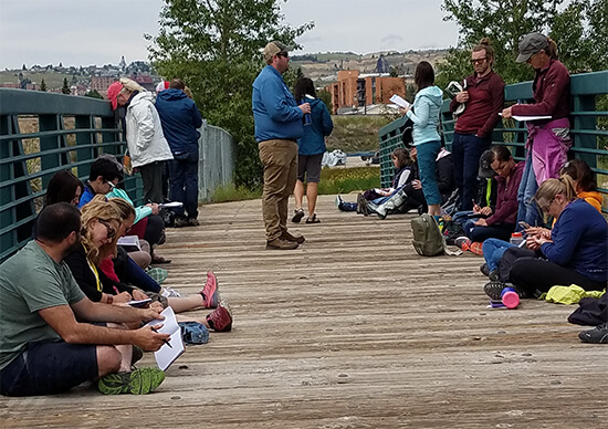 Educators work on their writing while at the Silver Bow Creek reclamation area.