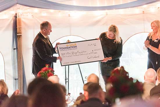 Dr. Edelman accepts donation at the Wine and Food Festival